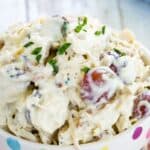 Chicken salad in a bowl with text overlay that says "Chicken Salad with Grapes & Walnuts"