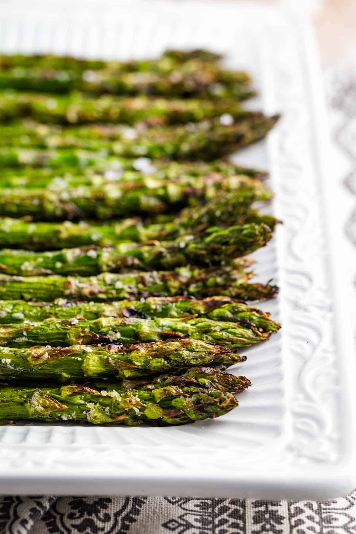 Crisp ends of grilled asparagus on a plate.