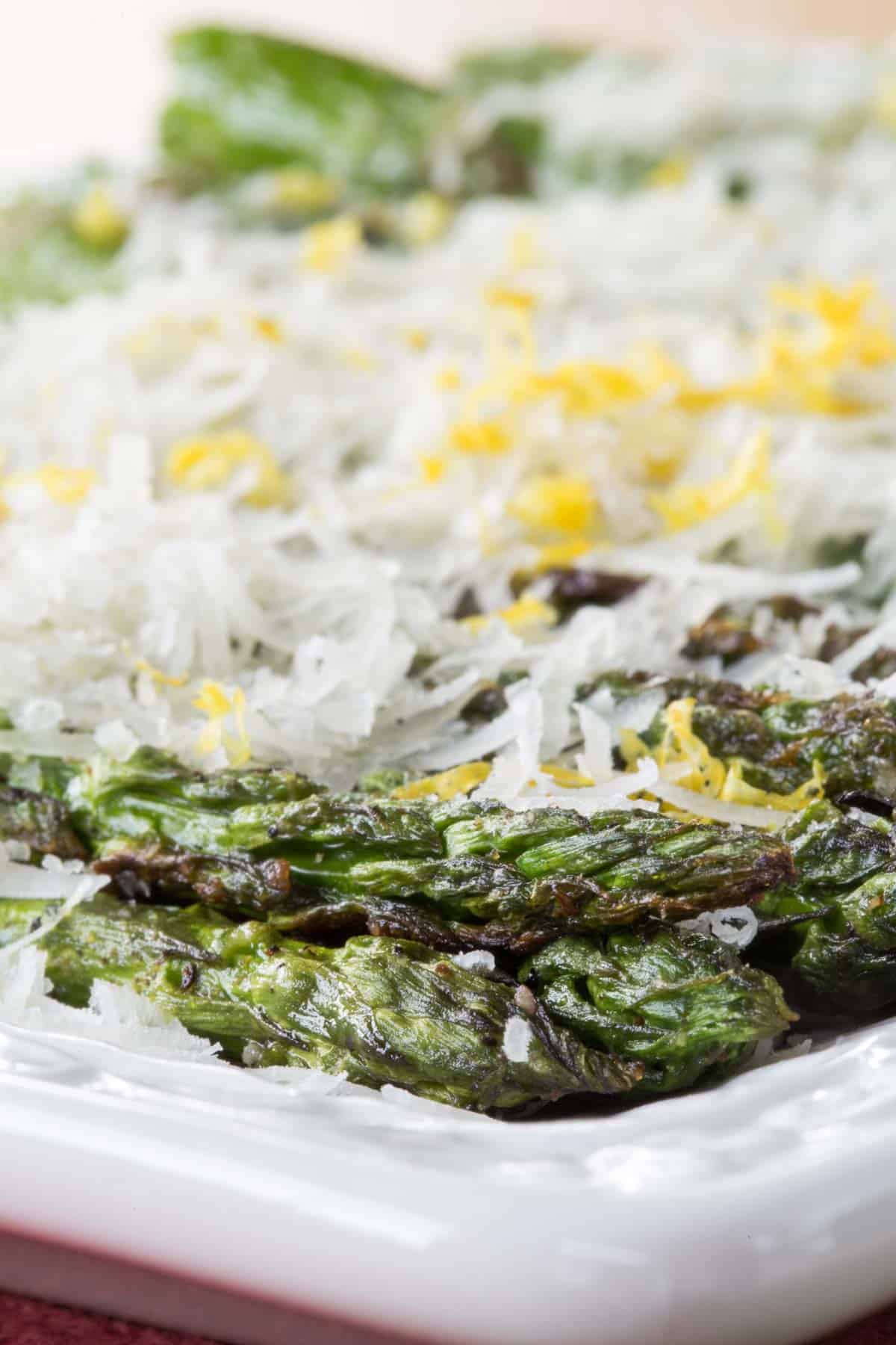 Parmesan cheese and lemon zest top grilled asparagus.