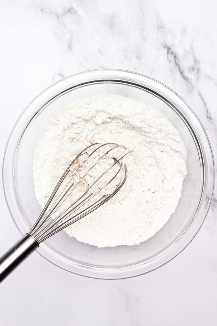 Banana bread flour mix is whisked in a bowl.