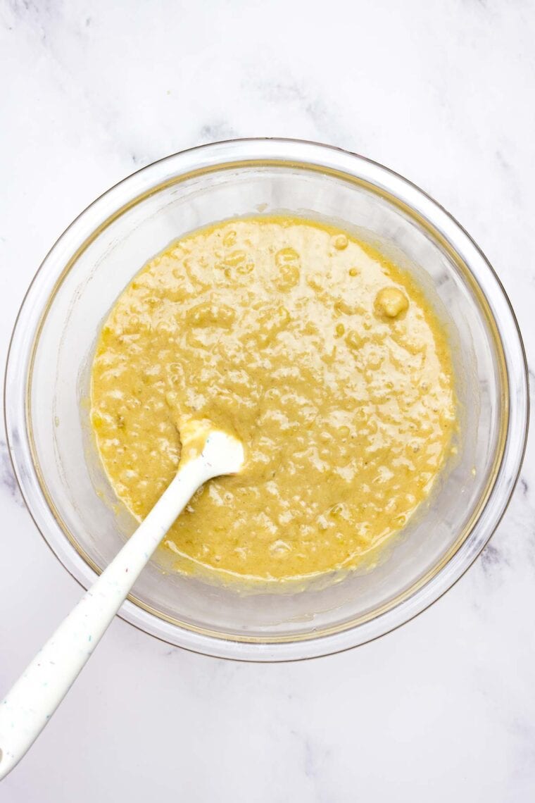 Mixing gluten-free banana bread batter in a bowl.