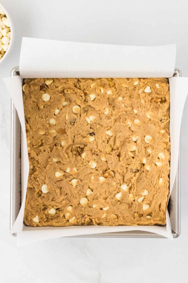 A lined baking pan of blondie batter.