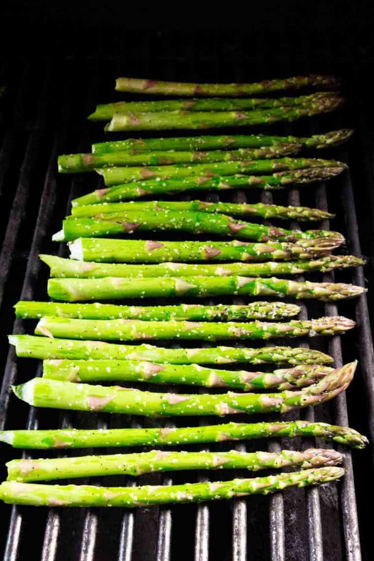 Spears of asparagus on a grill.
