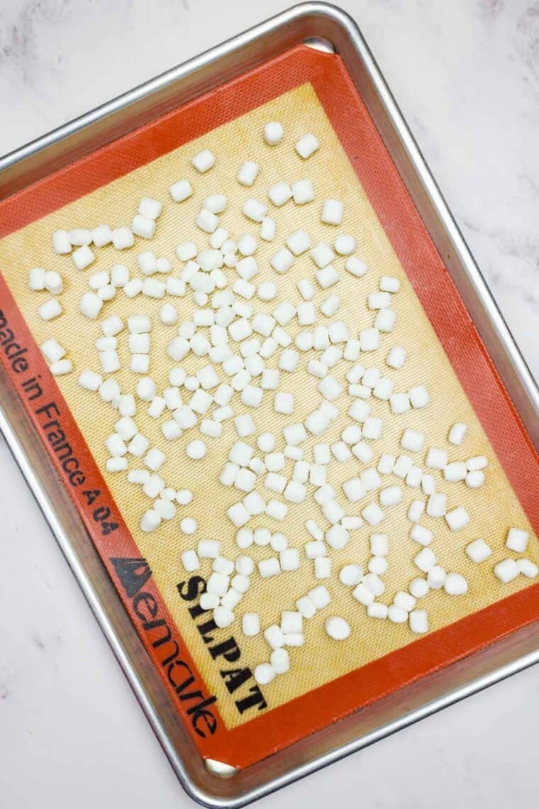 Mini marshmallows on a baking sheet.