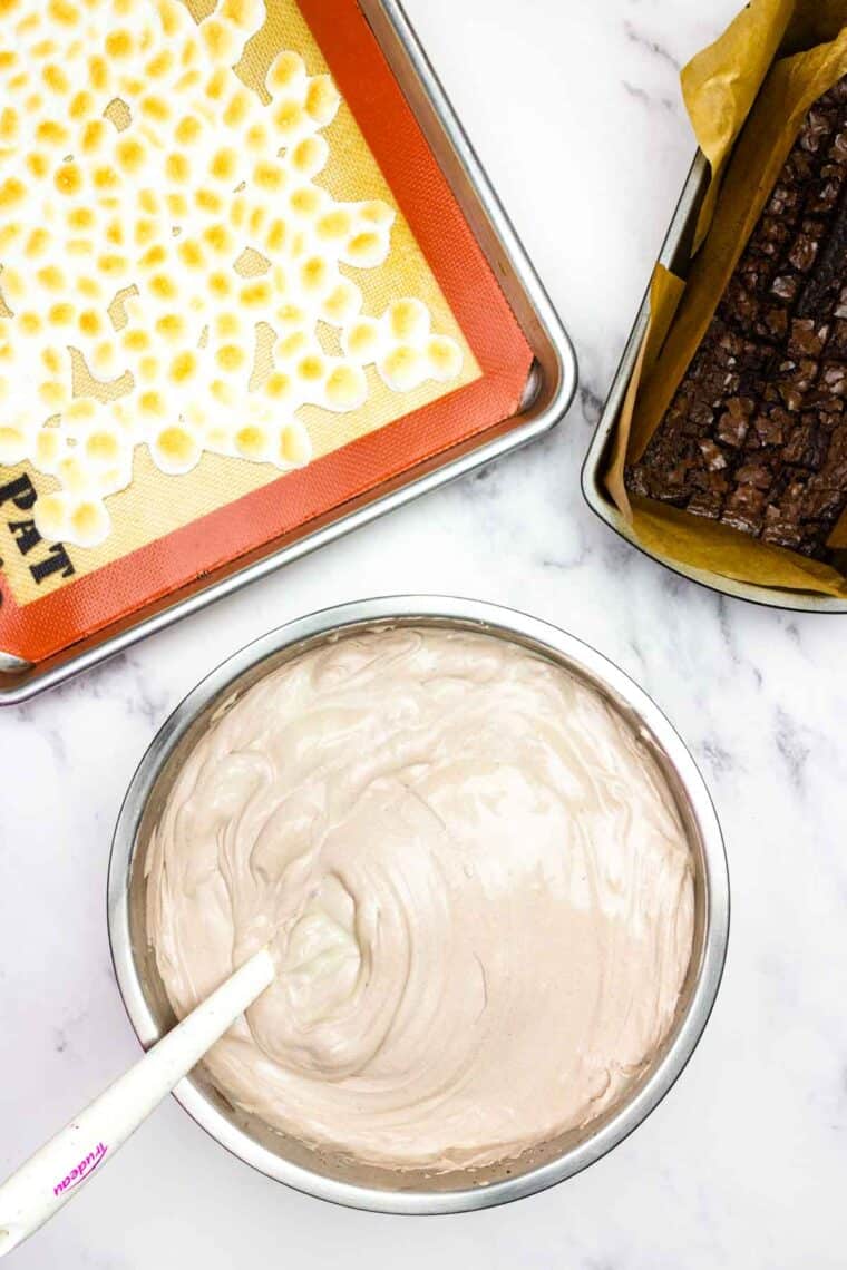 Condensed milk is stirred into ice cream base.