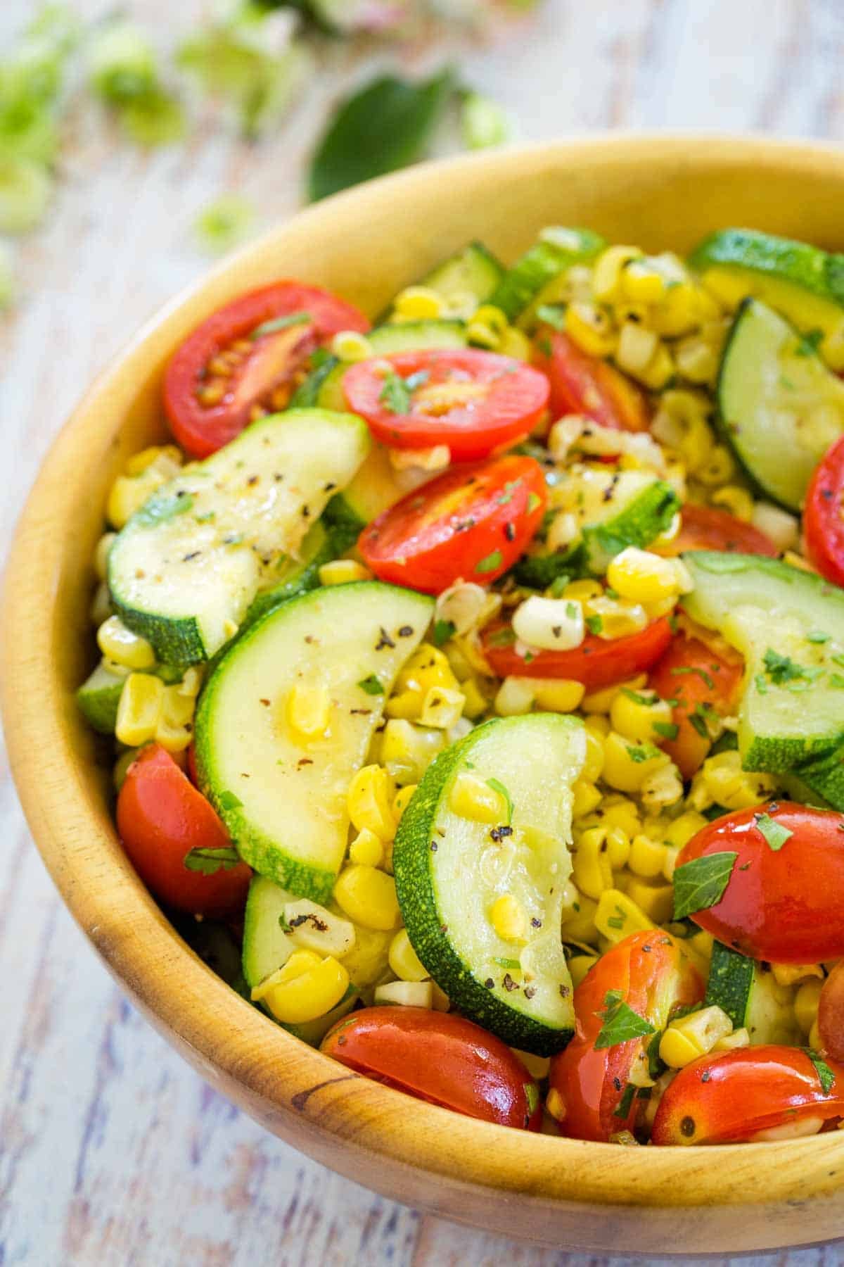 An easy side dish of fresh sauteed vegetables with just enough browned butter for a nutty, rich flavor. Celebrate summer's bounty! A big wooden bowl holds freshly sauteed summer vegetables.