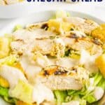 A bowl of salad with text overlay that says "Chicken Caesar Salad".