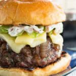A French onion burger on a blue plate.