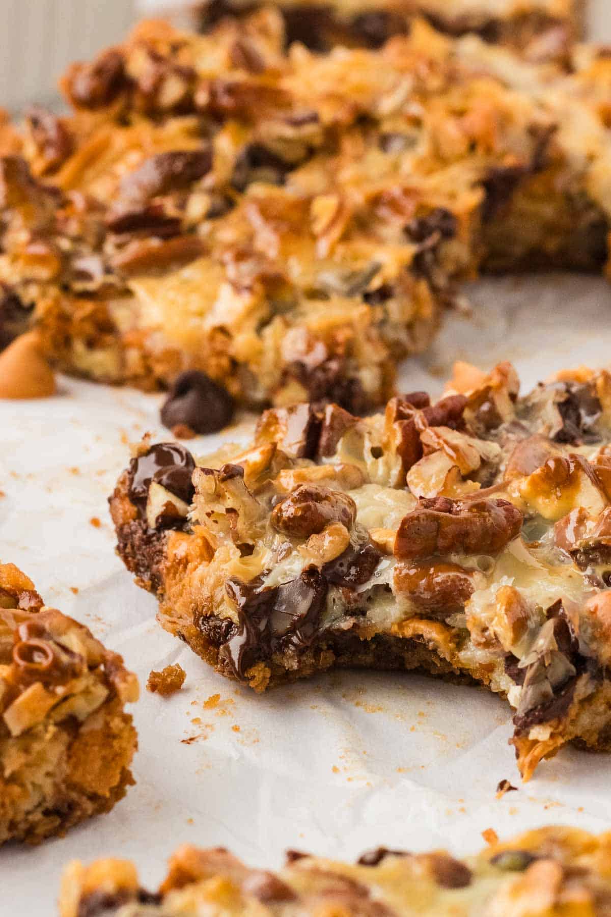 Closeup image of a 7 layer bar with a bite taken out of it.
