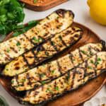 Grilled zucchini on a wooden plate.