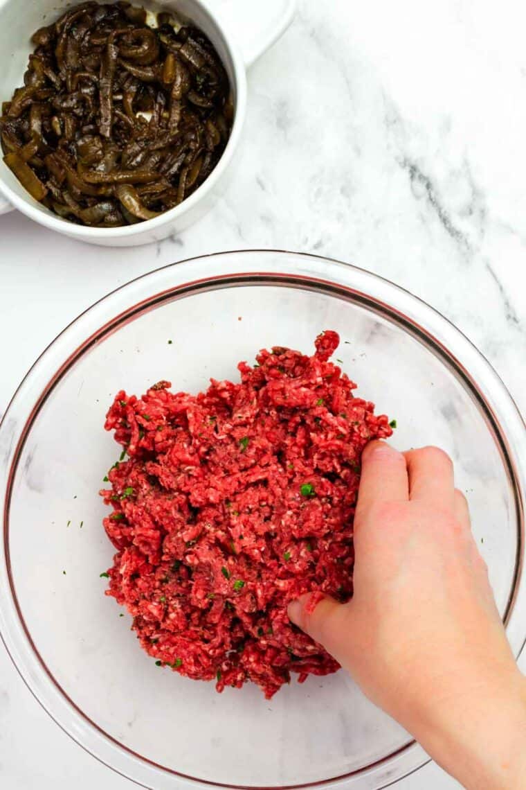 Seasoning burger meat.