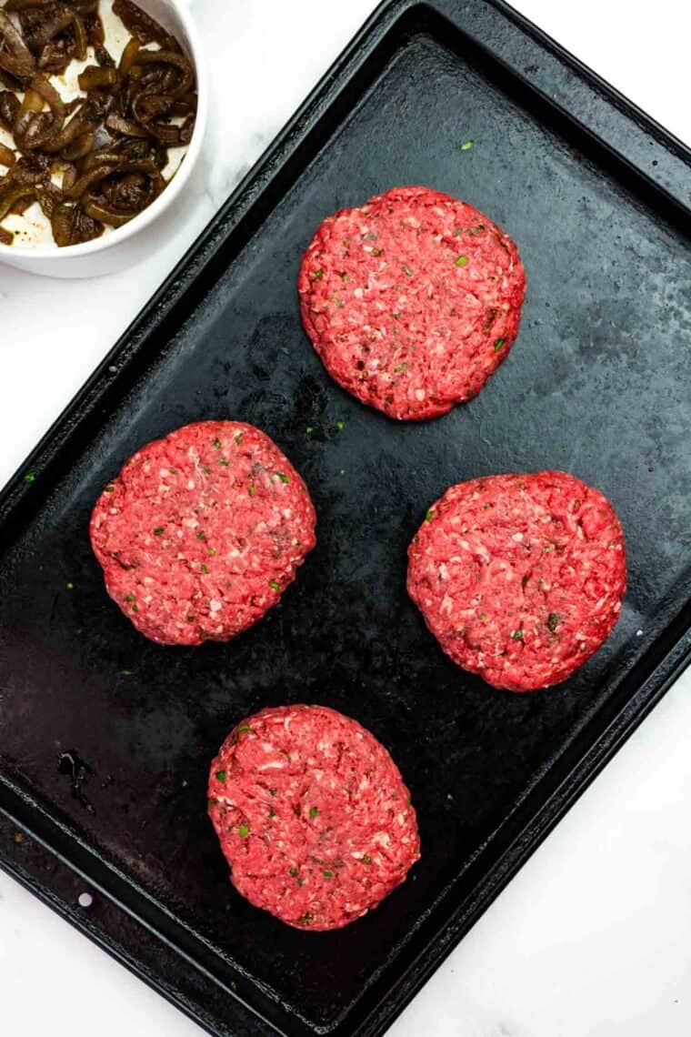 French onion burgers stuffed and ready to grill.