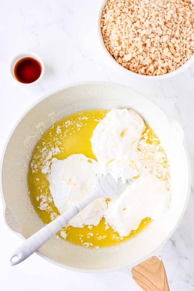 Melting marshmallow fluff and butter together in a Dutch oven.