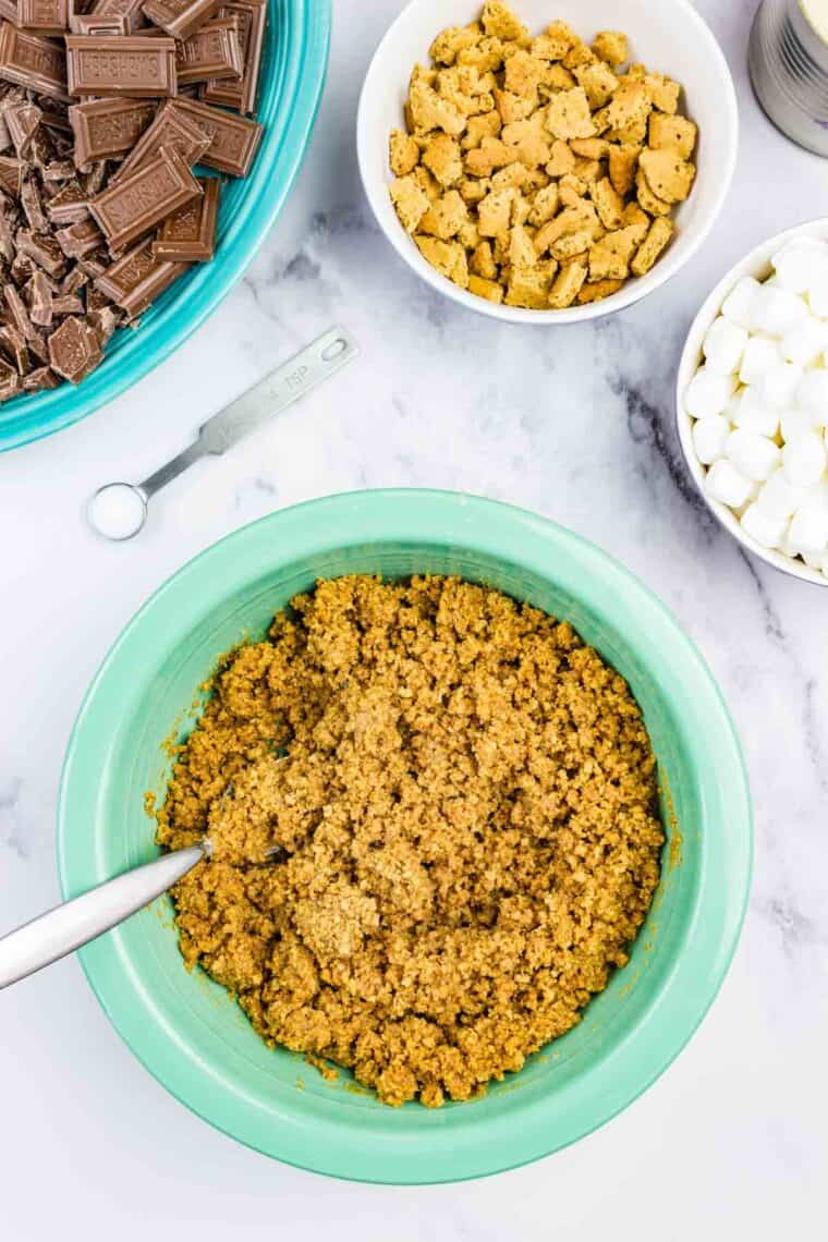 Graham cracker crumbs and melted butter mixed together in a bowl.