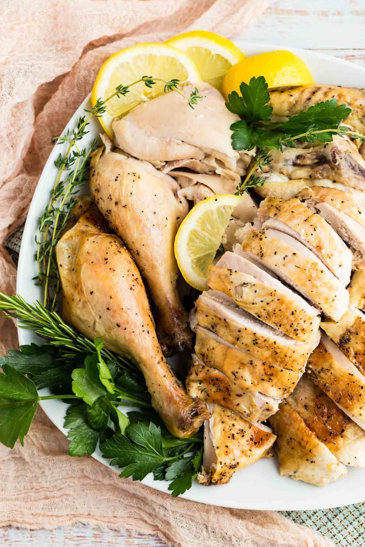Overhead of lemon roast chicken on a platter.
