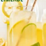 A glass of lemonade with paper straws with text overlay that says "Lemon Limeade".