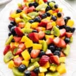 Mango berry fruit salad on a serving platter.