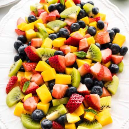 Mango berry fruit salad on a serving platter.