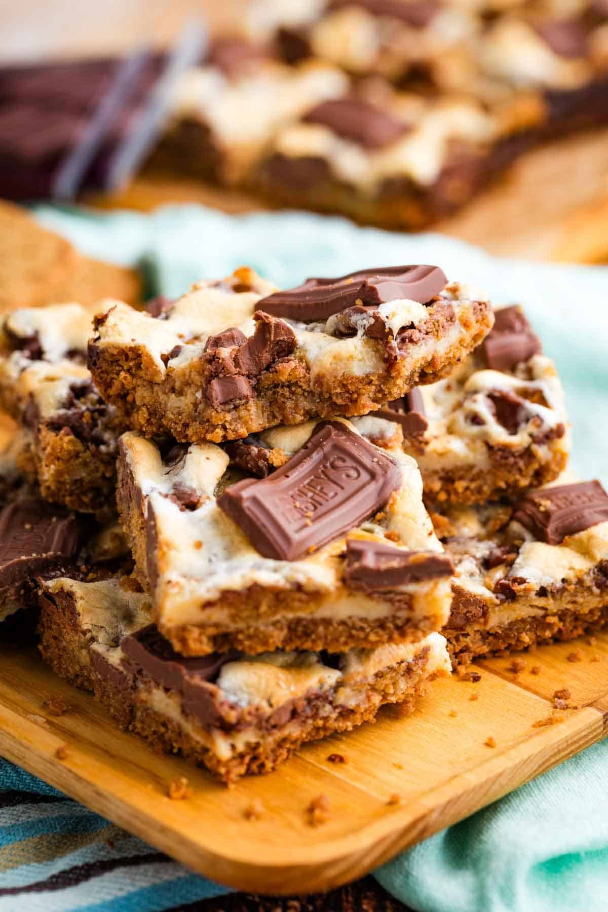 Close-up image of s'more bars stacked on a cutting board.