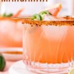 A pink drink in a glass garnished with jalapeno slices with text overlay that says "Spicy Grapefruit Margarita".