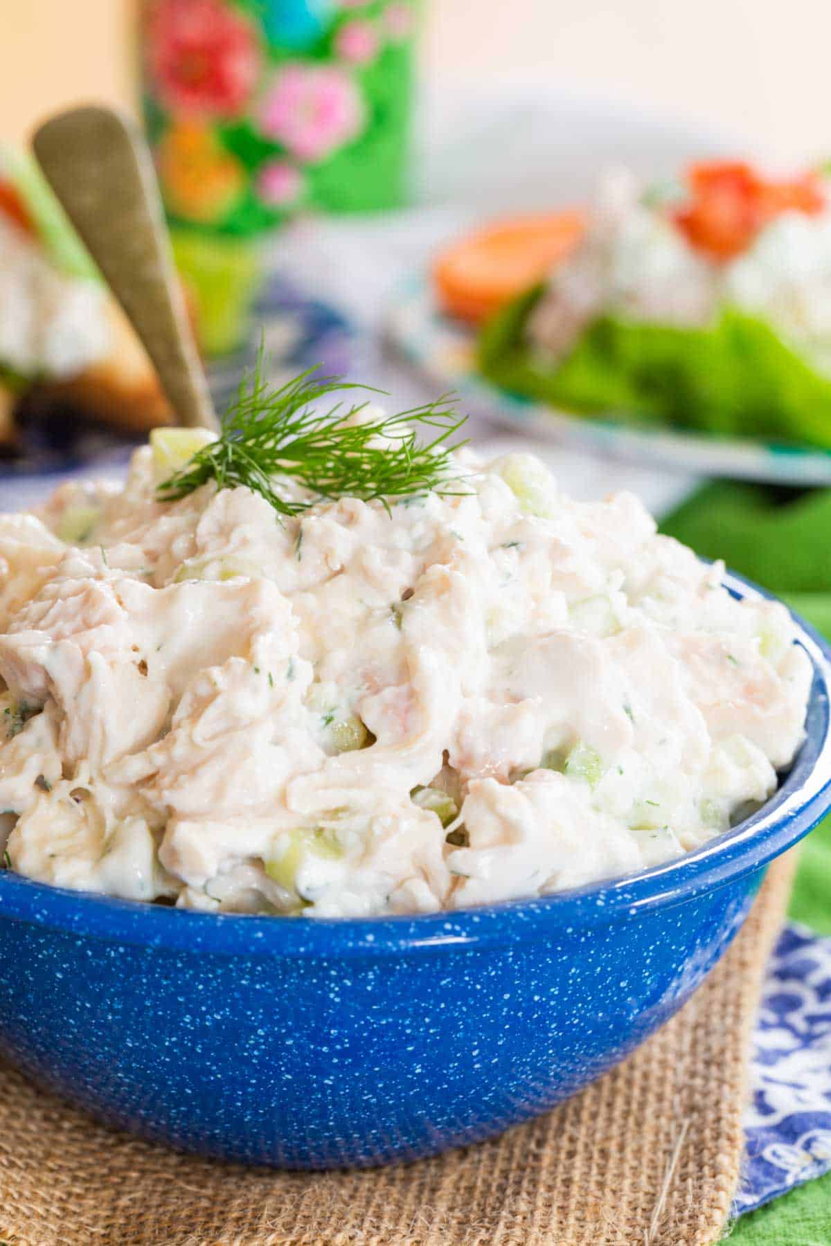 This Greek-ish tzatziki chicken salad combines juicy chicken, crunchy cucumber, and tangy Greek yogurt dressing with lemon, dill, and garlic. Close-up image of a bowl of tzatziki chicken salad.