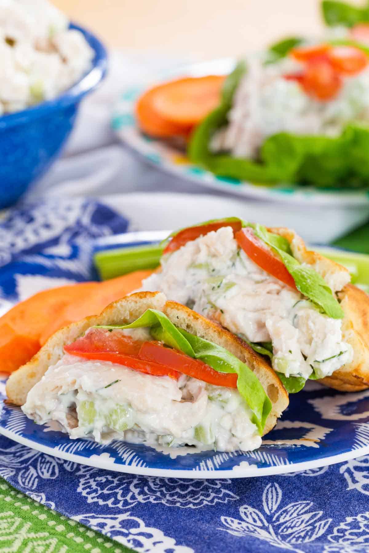 This Greek-ish tzatziki chicken salad combines juicy chicken, crunchy cucumber, and tangy Greek yogurt dressing with lemon, dill, and garlic. Tzatziki chicken salad in pita pockets with lettuce and tomato.