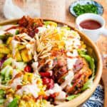The best BBQ chicken and pineapple salad in a wooden salad bowl.