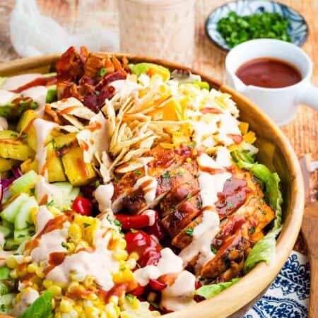 The best BBQ chicken and pineapple salad in a wooden salad bowl.