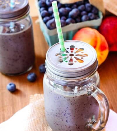 Blueberry peach smoothie in a jar.