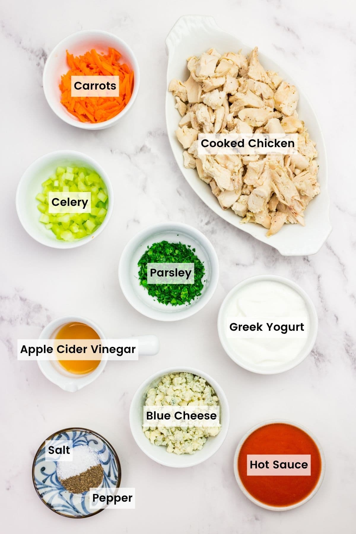 This flavor-packed Buffalo Chicken Salad is made with bold Greek yogurt dressing, tender chicken, crunchy veggies, and blue cheese. Yum! Labeled ingredients for buffalo chicken salad.