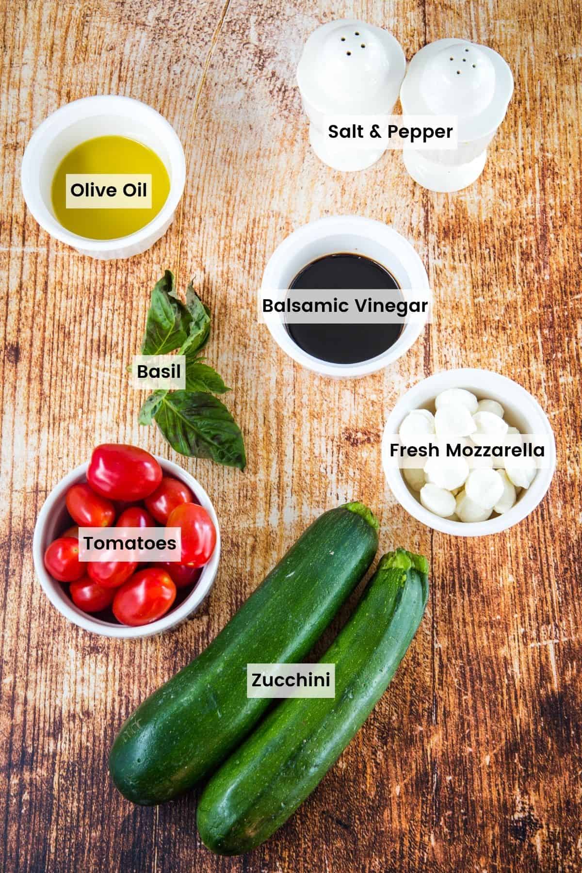 Ingredients to make Caprese zucchini noodles with text labels.
