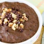 A bowl of chocolate oatmeal with text overlay that says "Chocolate Zucchini Protein Oatmeal".