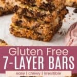 A stack of chewy bars with a graham cracker crust and one with a bite taken out divided by a pink box with text overlay that says "Gluten Free 7-Layer Bars" and the words easy, chewy, and irresistible.