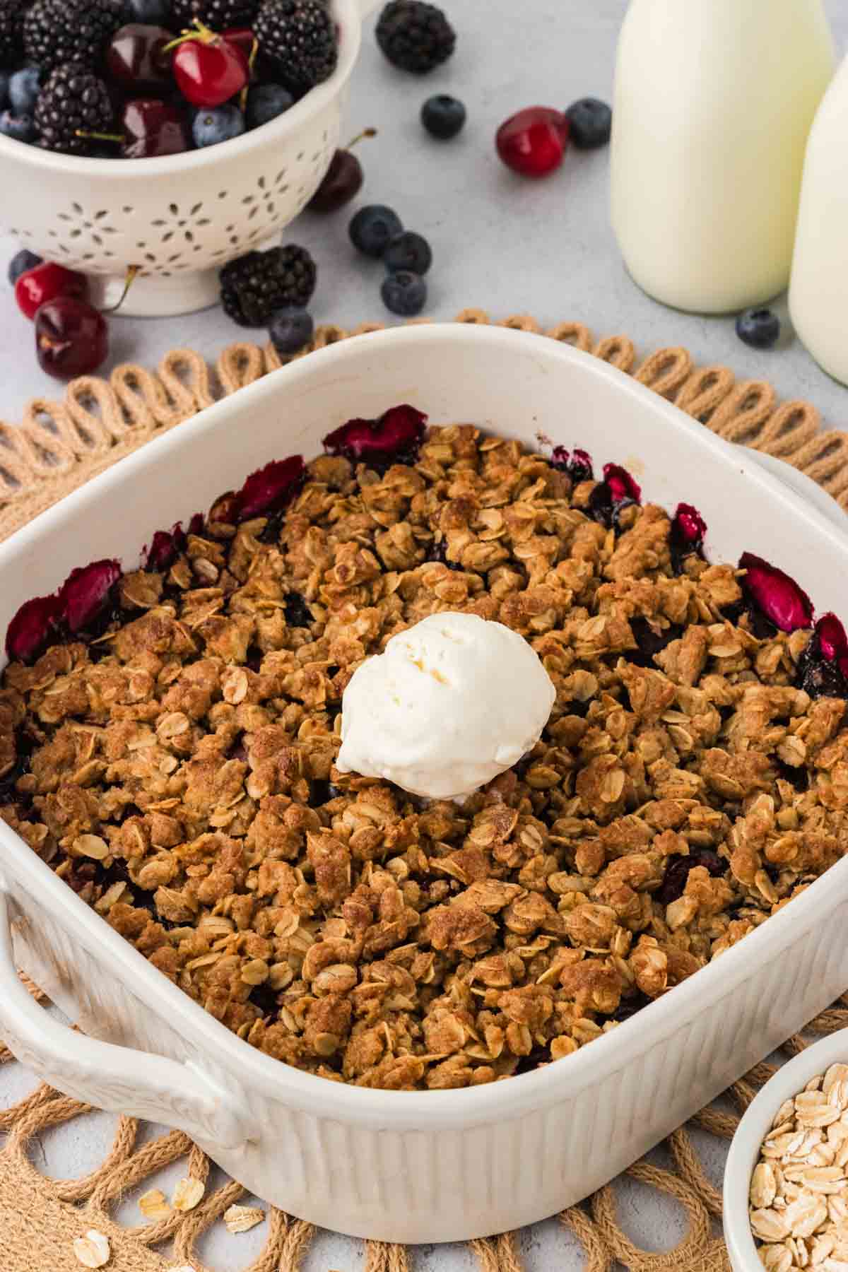 Gluten-free berry crisp with ice cream on top.