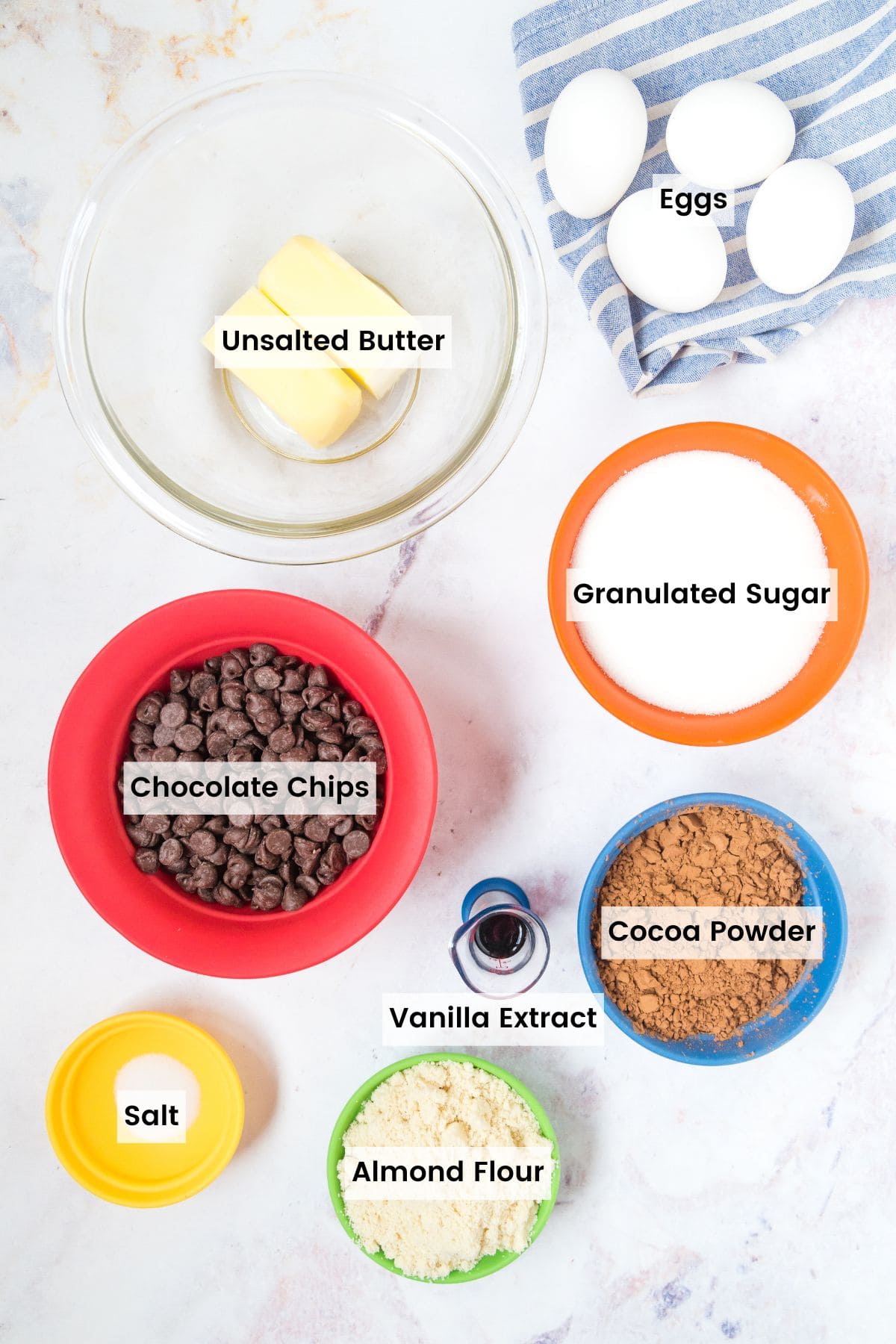 Bowls of ingredients to make gluten free brownies with text labels.