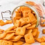 Cheddar crackers pouring out of a jar.