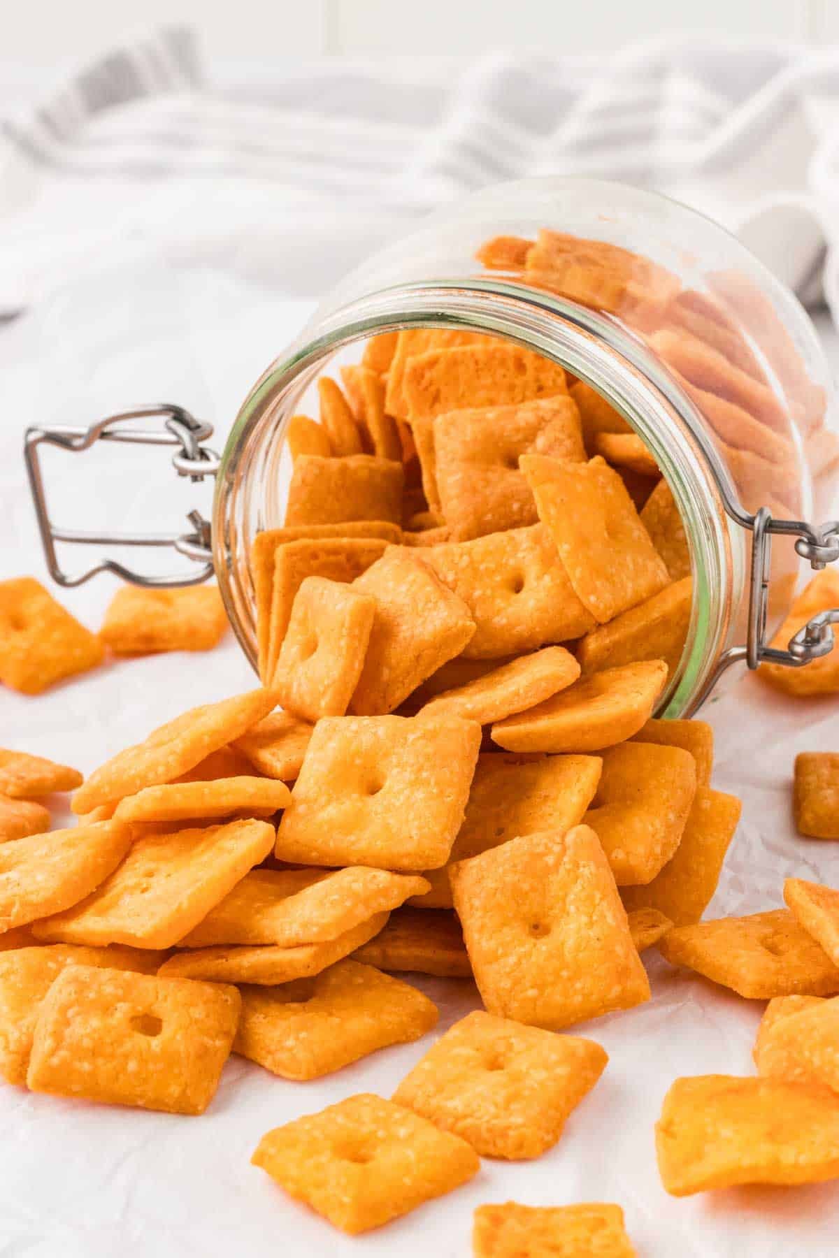 Cheddar crackers pouring out of a jar.