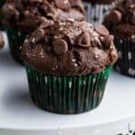 Chocolate muffins on a tray with text overlay that says "Gluten Free Chocolate Zucchini Muffins".