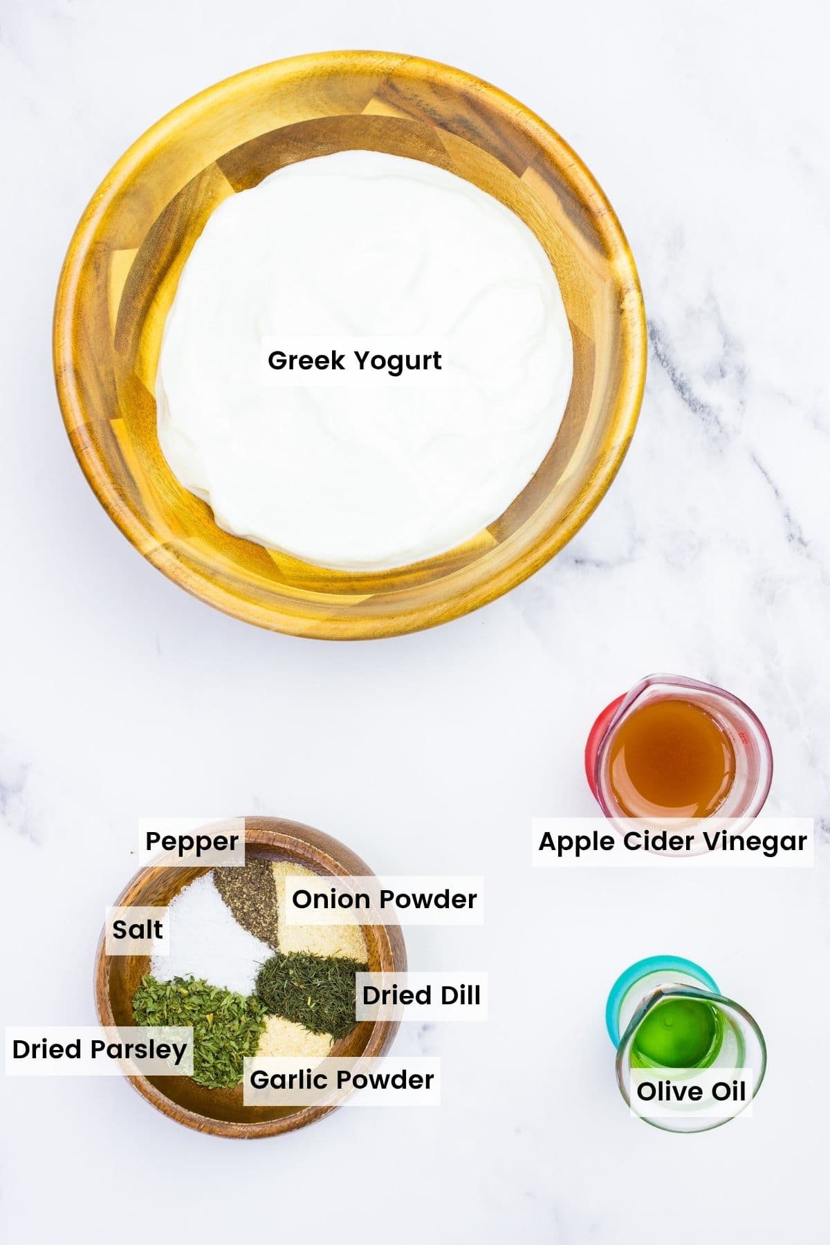 This Greek yogurt ranch dip is full of bold, herby flavors, perfect for scooping up with dippables or spreading it over a juicy burger. Labeled ingredients for Greek yogurt ranch dip.