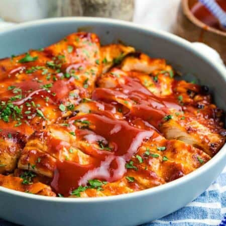 Sliced BBQ grilled chicken breast in a shallow bowl.