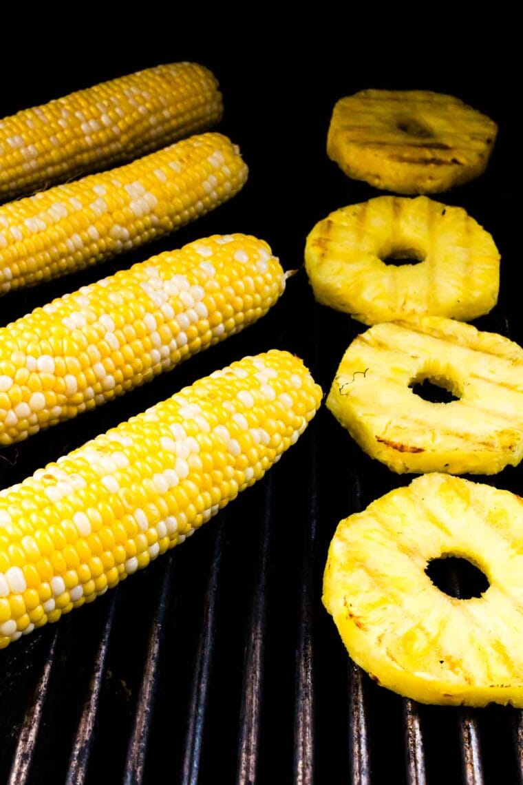This BBQ chicken salad is loaded with BBQ chicken, crispy bacon, juicy pineapple, creamy avocado, and more. A sweet and savory masterpiece. Corn and pineapple rings on the grill.
