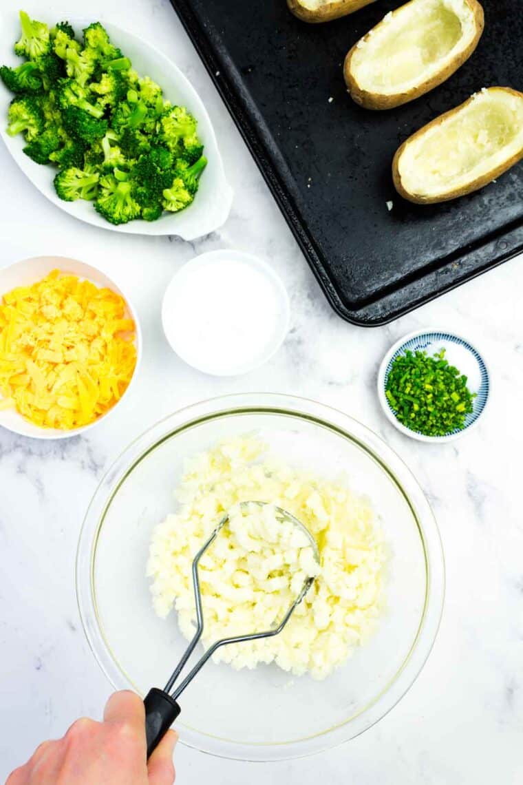Mashing potatoes in a bowl.