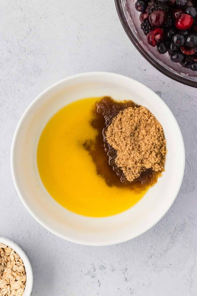 Mixing together melted butter and brown sugar.