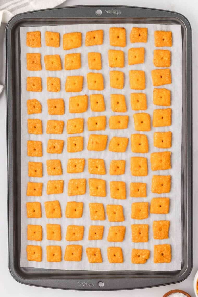 GF cheddar crackers cooling on a baking sheet.