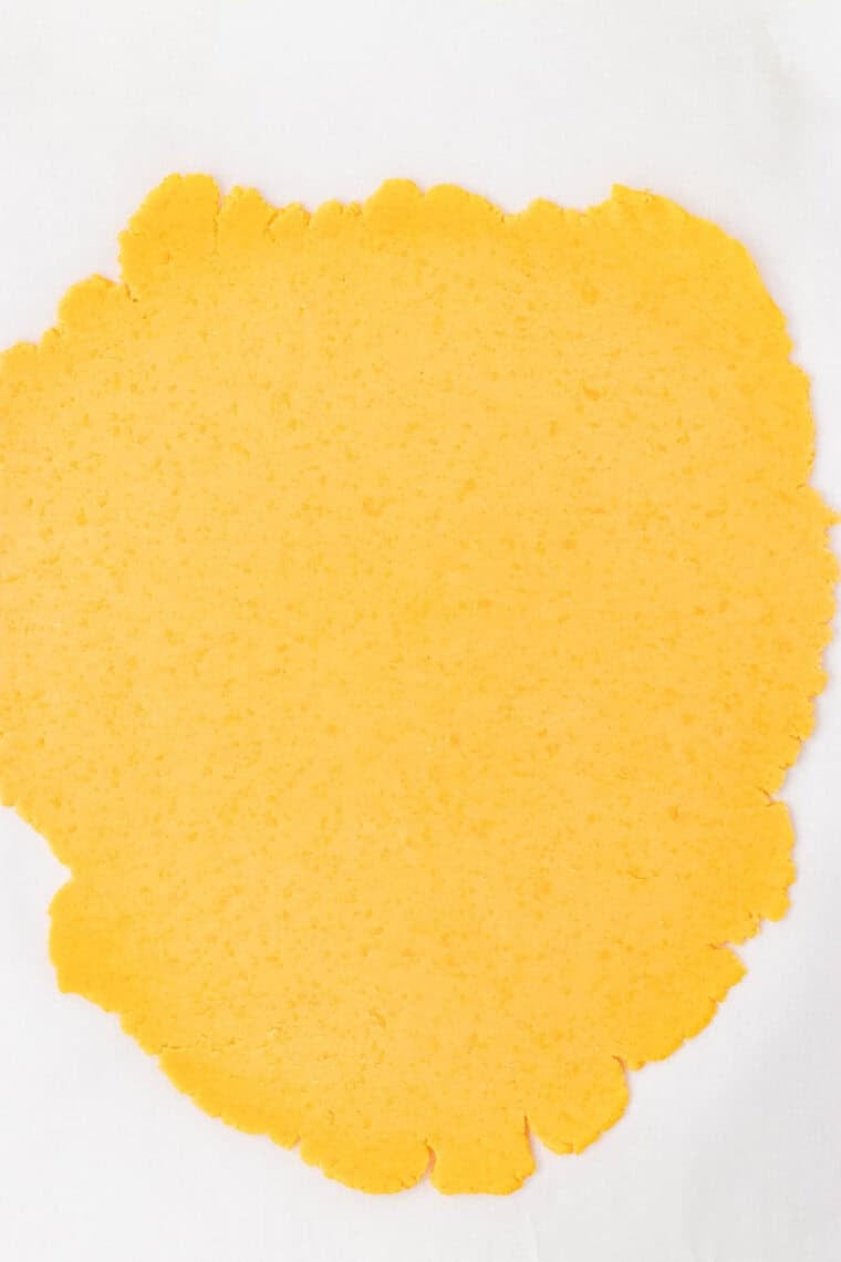 Rolling out GF cheddar cracker dough.