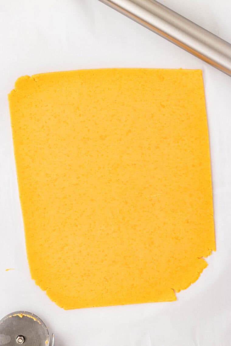 GF cheddar cracker dough cut into a larger square.