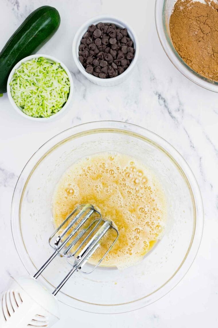 These gluten-free chocolate zucchini muffins are packed with melty chocolate chips and incredibly moist and tender, thanks to the zucchini. Whisking together maple syrup, oil, applesauce, granulated sugar, eggs, and vanilla extract.