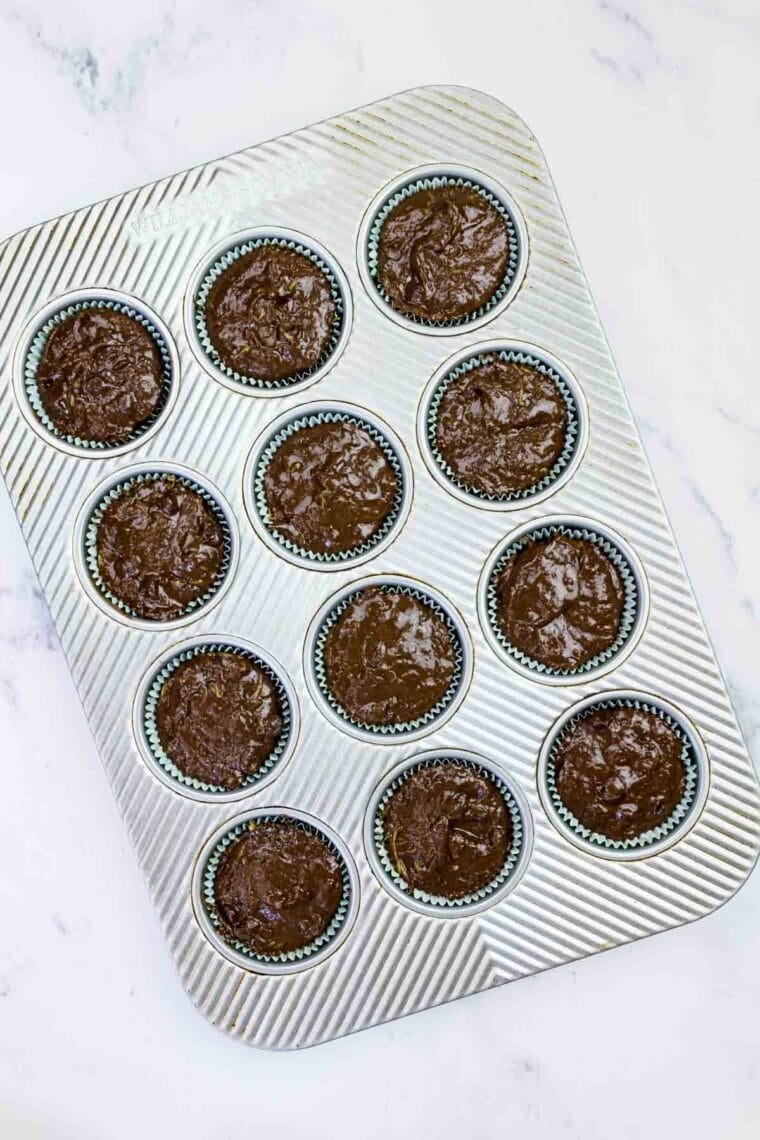 Chocolate chocolate chip zucchini batter in muffin tins.