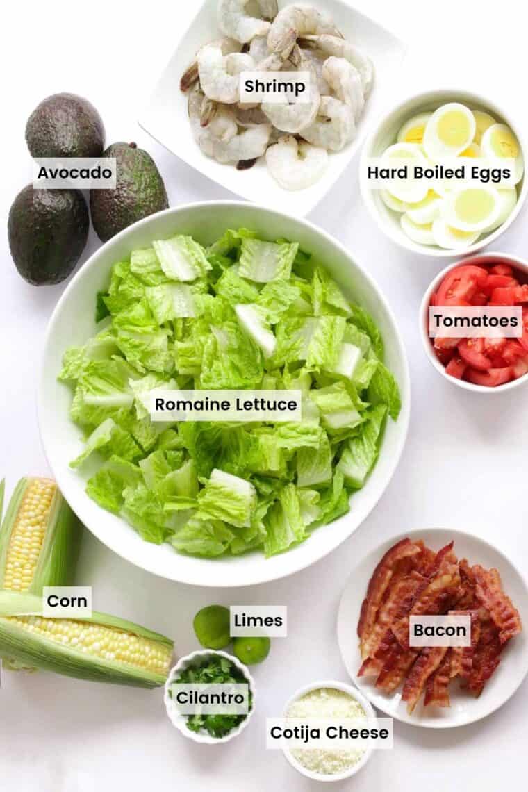 Ingredients to make Southwest Shrimp Salad in bowls with text labels.