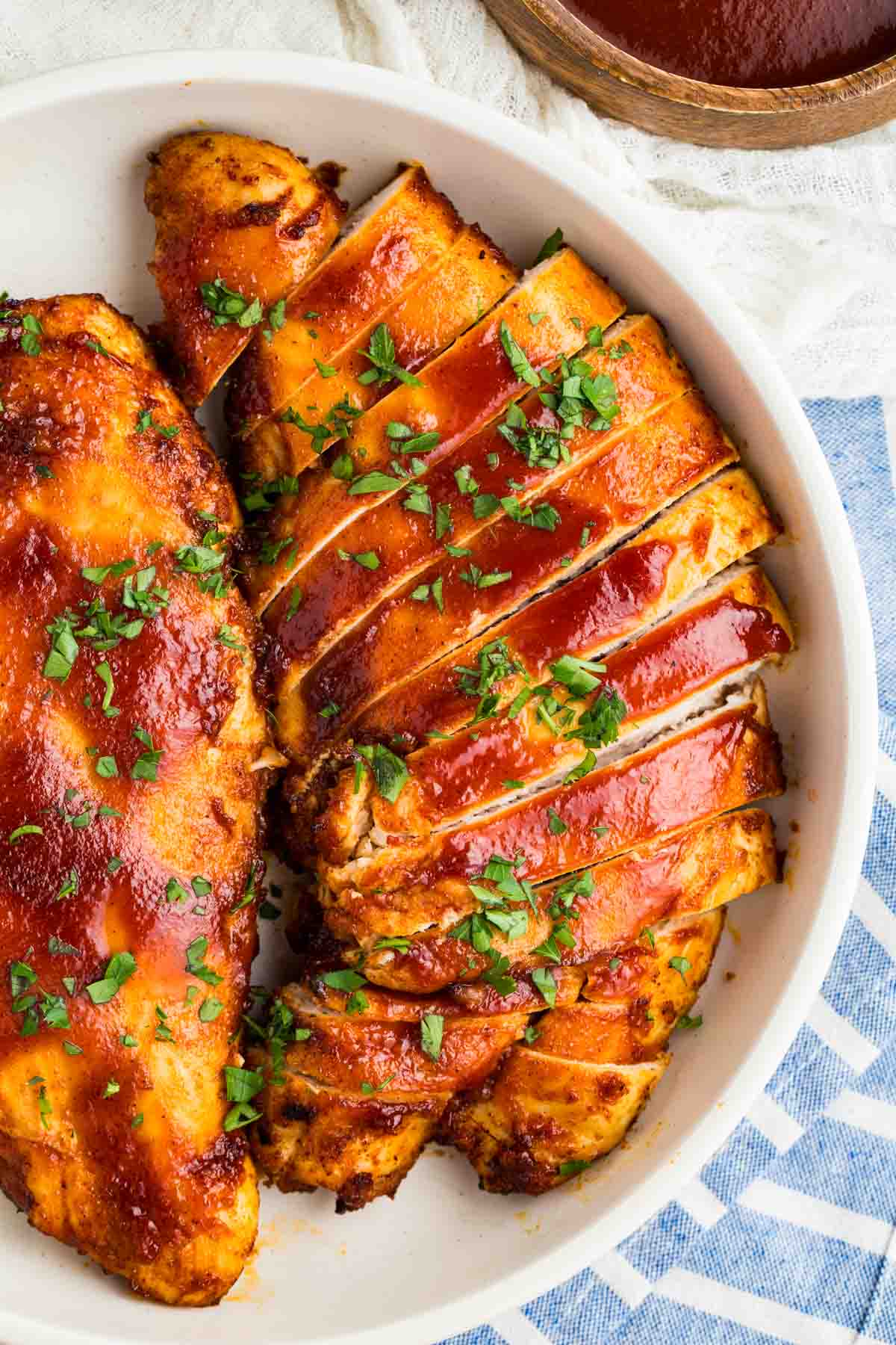 Overhead image of two air fryer BBQ chicken breasts. One is sliced. One is not.